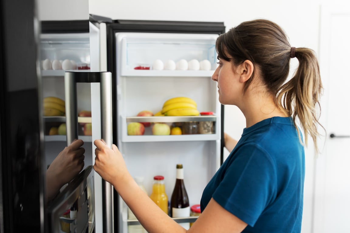 Woman at Open Fridge at Home Kitchen